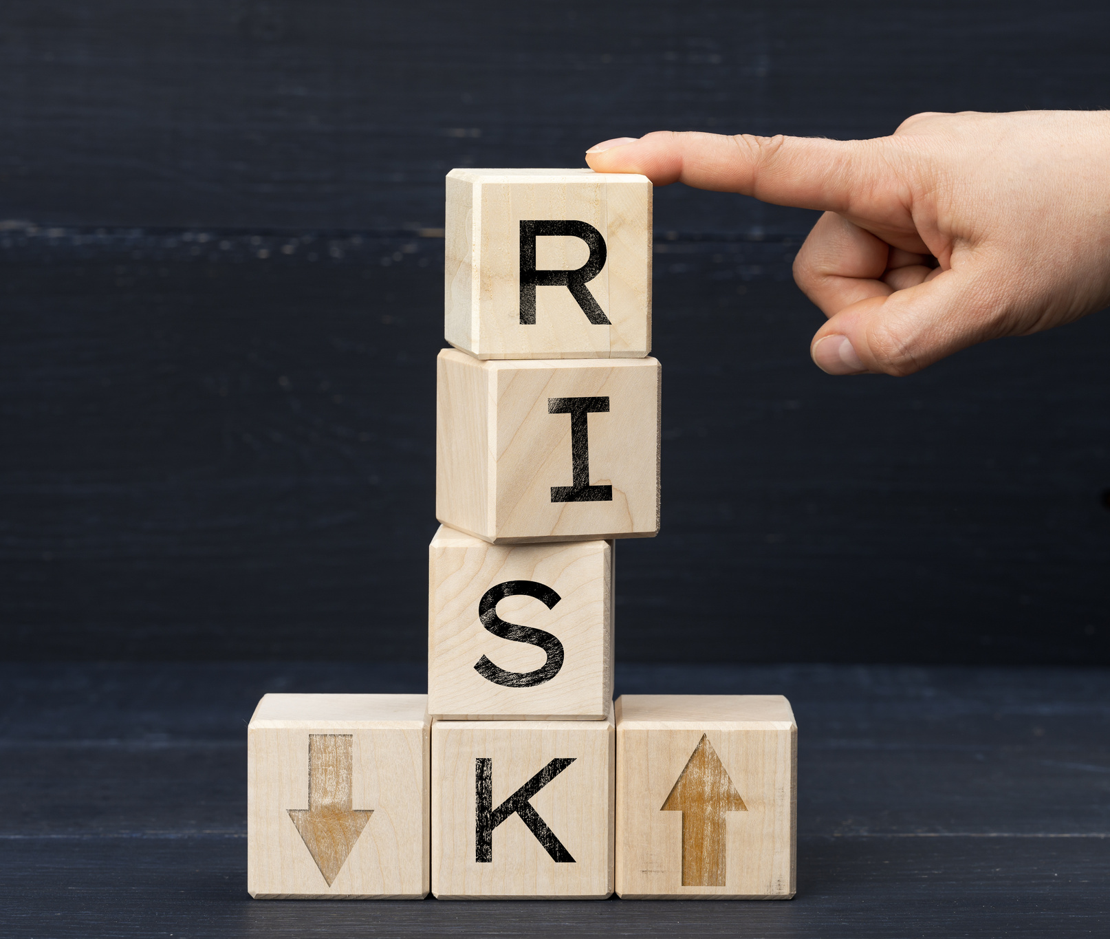 wooden cubes with the inscription risk on a blue background. Risk reduction concept, reinsurance